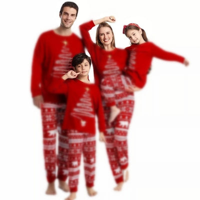 Family of four wearing matching red Christmas pajamas with a Christmas tree graphic and fair isle pattern. - Image 2