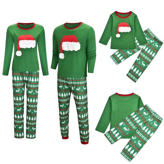 Green Christmas family pajama sets with Santa hat graphic tops and pants featuring reindeer, trees, and snowflakes. - Image 11