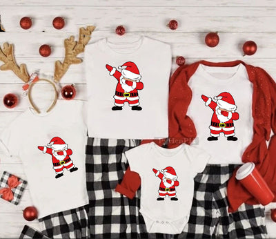 Family matching white Christmas t-shirts and baby bodysuit with 'Merry Christmas' graphic, paired with black and white plaid pajama bottoms. - Image 15