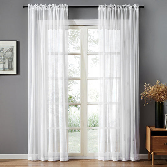 Sheer pink rod pocket curtain hanging on a black curtain rod, offering light transmission for a modern room.