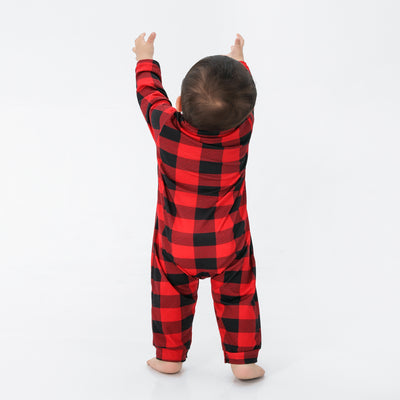 Baby in a red and black buffalo plaid long-sleeve pajama romper, viewed from the back with arms raised. - Image 25