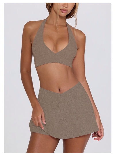 Light pink halter neck sports bra and high-waisted leggings workout set on a model. - Image 37