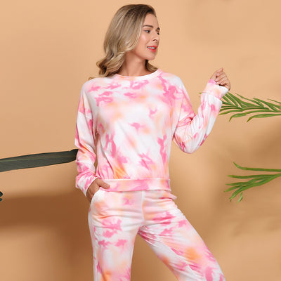 Woman wearing a pink and white tie-dye long-sleeve top and matching pants set, posing casually. - Image 8