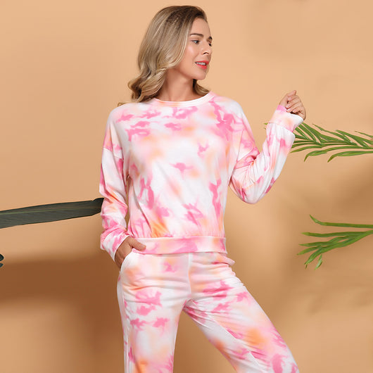Woman wearing a pink and white tie-dye long-sleeve top and matching pants set, posing casually. - Image 8