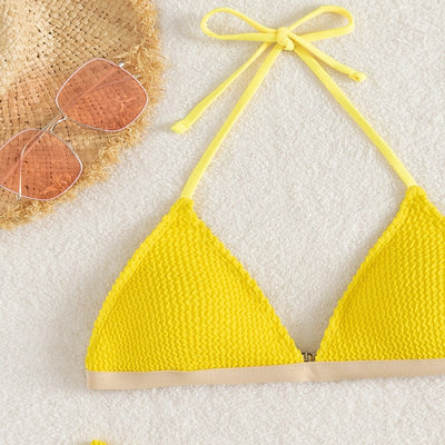 Bright yellow textured two-piece bikini with a triangle top and high-cut bottom, modeled on a person. - Image 12