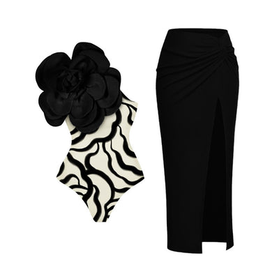 Black one-piece swimsuit with a large 3D flower on one shoulder and a geometric pattern on the bodice. - Image 6
