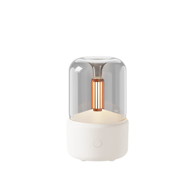 White cylindrical aroma diffuser with a clear top and an amber candlelight-effect LED light. - Image 13