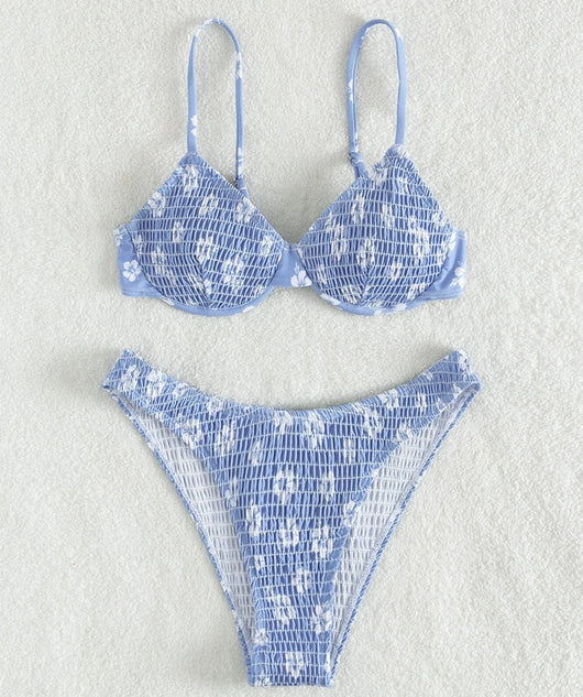 Periwinkle blue two-piece swimsuit with white floral pattern and ruched texture, featuring an underwire bikini top and high-cut bottoms. - Image 15