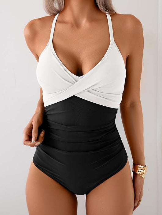 Women's black and white one-piece swimsuit with a twisted halter top and ruched detailing on the bottom. - Image 7