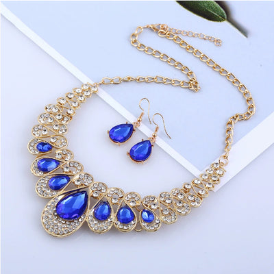 Gold-tone necklace and matching drop earrings set with clear teardrop gems and sparkling rhinestones. - Image 12
