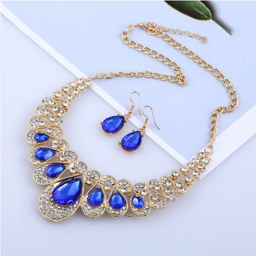 Gold-tone necklace and matching drop earrings set with clear teardrop gems and sparkling rhinestones. - Image 12