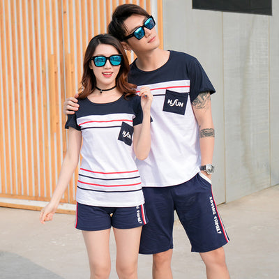 Navy blue children's shorts with white ribbed waistband, beige drawstring, and side pockets. Features red, white, and black side stripes and "LOVING FAMILY" tex - Image 8