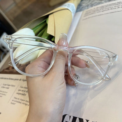 Retro square transparent full-frame glasses with blue light lenses, held by a person wearing grey sweatpants. - Image 11