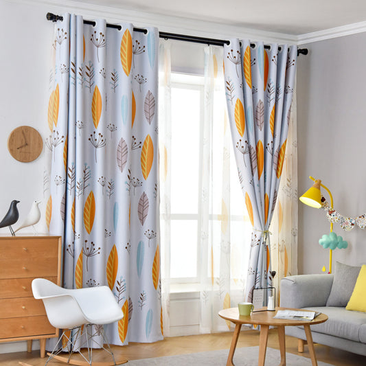 Nordic style light blue blackout curtains with yellow, blue, and brown leaf pattern in a modern living room.