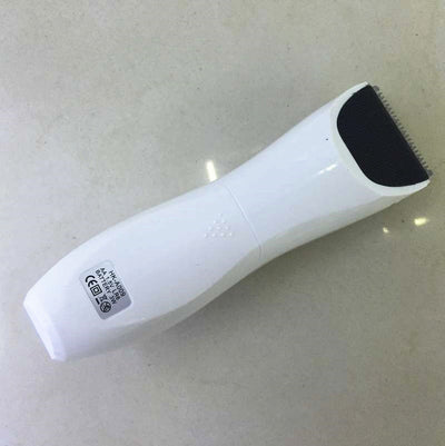 White and silver electric hair clipper held in hand, with a grey guide comb and blue packaging on a woven surface. - Image 11