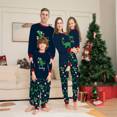 Blue baby long-sleeved pajama set with red trim, featuring a Christmas dinosaur wrapped in lights and "baby" text.