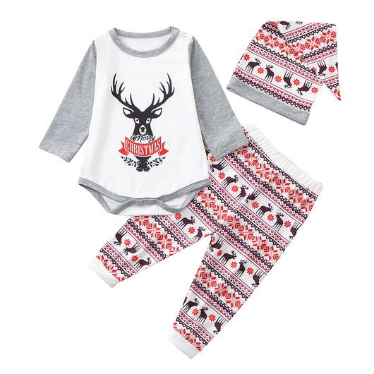 Young boy wearing a Christmas pajama set with a white and grey raglan top featuring a reindeer and fair isle print pants. - Image 6