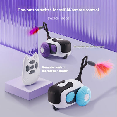 White and black remote control cat toy car with purple wheels and an orange feather, next to a white cat-shaped remote. - Image 2