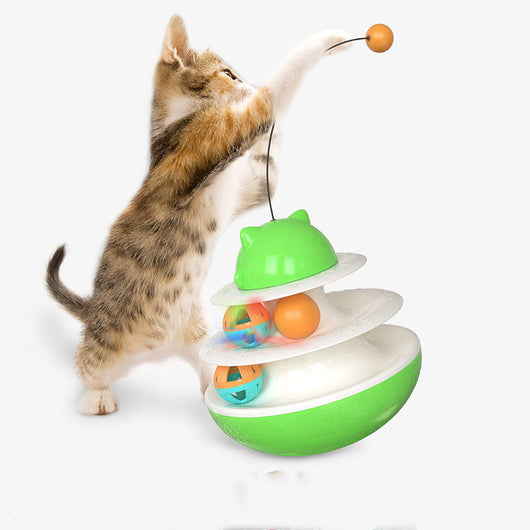 A playful kitten stands on its hind legs, batting at a dangling toy attached to a green and white multi-level cat track toy with rolling balls. - Image 6