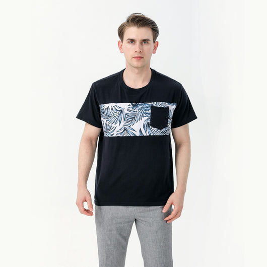 Young boy wearing a white short-sleeve t-shirt with blue tropical leaf print and a black chest pocket. - Image 11