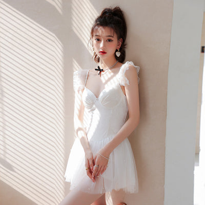 White one-piece swimsuit with a textured bodice, ruffled lace shoulder straps, and a sheer tutu-style skirt. - Image 10