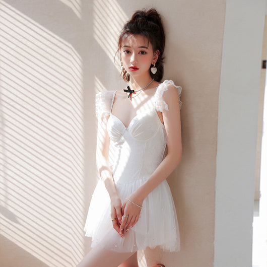White one-piece swimsuit with a textured bodice, ruffled lace shoulder straps, and a sheer tutu-style skirt. - Image 10