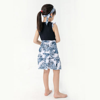 Young boy wearing a white short-sleeve t-shirt with blue tropical leaf print and a black chest pocket. - Image 14