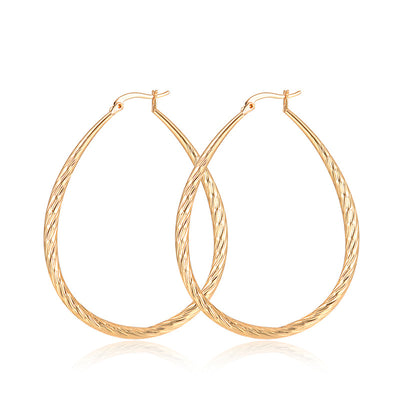 Aretes Dorados en Gota con Textura y Acabado Mate - Image 10