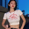 Playera Estampada Ajustada con Cintura Descubierta y Detalle de Jaula