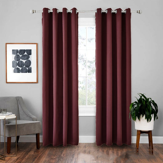 Light gray polyester blackout curtains with grommet tops hanging on a white rod in a modern living room. - Image 7