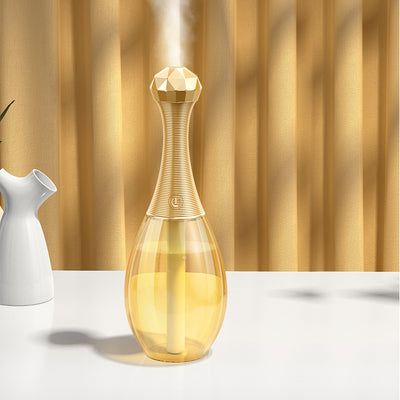 Mini silent portable humidifier shaped like a perfume bottle, with a clear body and a gold ribbed neck and faceted cap. - Image 13
