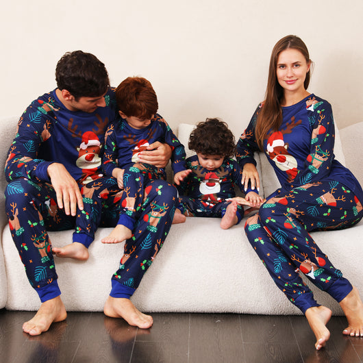 Family Christmas pajamas with a cartoon reindeer wearing a Santa hat and red scarf on a black top, and dark blue pants with a repeating reindeer and holly patte - Image 4