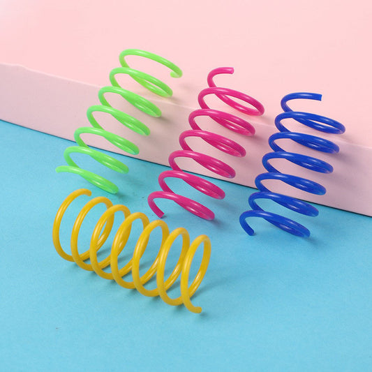 Colorful plastic spring cat toys in pink, yellow, green, and blue, packaged in a clear plastic bag.