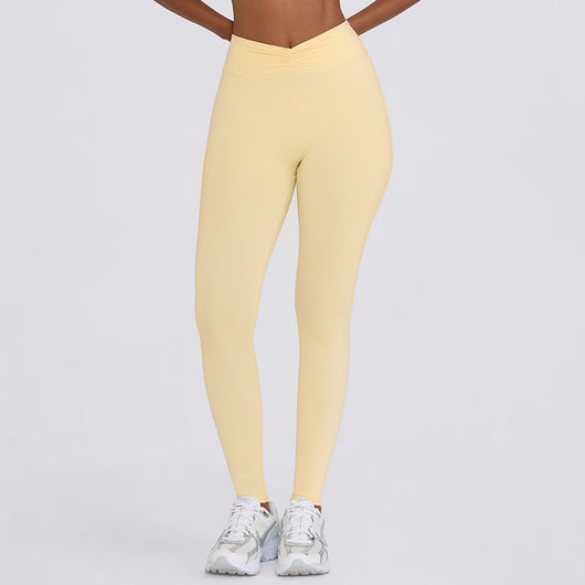 Light pink halter neck sports bra and high-waisted leggings workout set on a model. - Image 19