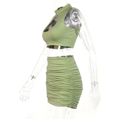Light green two-piece set featuring a sleeveless crop top with a high neck and chest cutout, paired with a ruched bodycon mini skirt. - Image 14