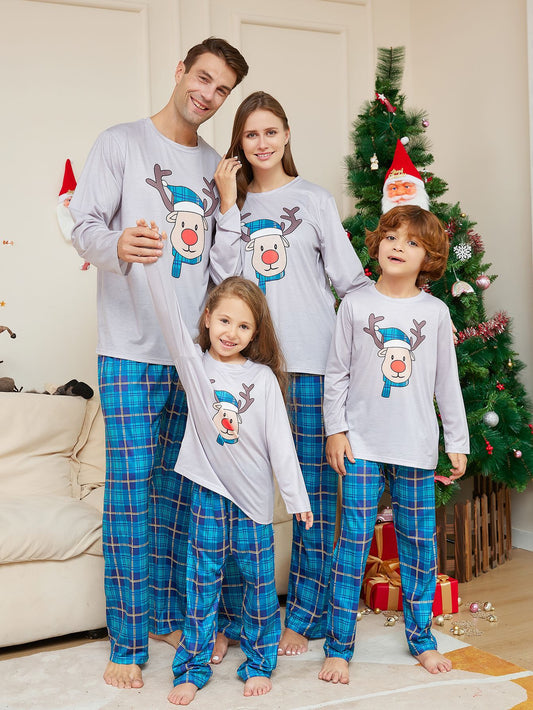Young girl wearing a grey long-sleeve pajama top with a cartoon reindeer and blue plaid pajama pants. - Image 2