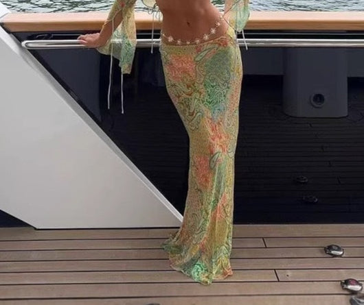 Halterneck two-piece swimsuit with a vibrant paisley print in blue, green, orange, and pink, featuring light blue straps. - Image 7