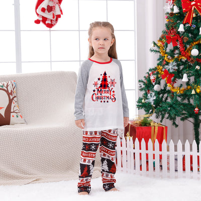 Family of four wearing matching Christmas pajamas with 'MERRY Christmas' text, leopard print, and plaid trees. - Image 18
