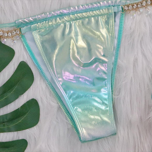 Iridescent purple and pink two-piece bikini with gold-toned crystal embellishments on a white faux fur background. - Image 33