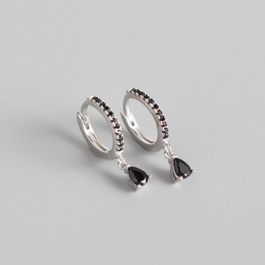 Silver-colored hoop earrings with black pave stones and dangling black teardrop-shaped stones. - Image 6