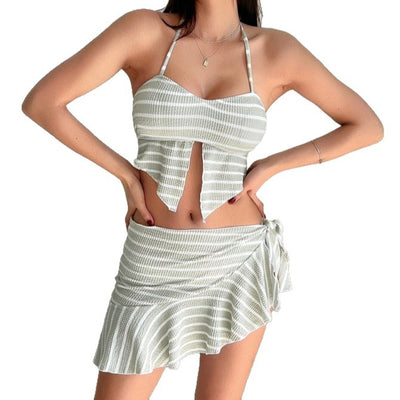 Woman in a light green and white striped two-piece swimsuit with a halter top and V-cut front hem. - Image 5
