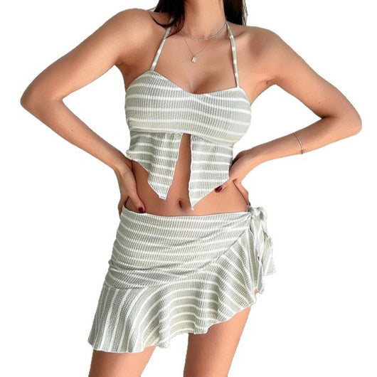 Woman in a light green and white striped two-piece swimsuit with a halter top and V-cut front hem. - Image 5