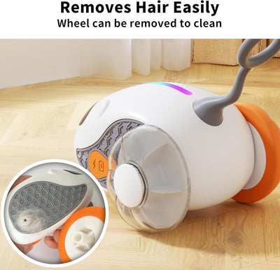 Interactive cat toy with white robotic base, orange wheels, and feather attachment, controlled by a remote, with a cat looking on. - Image 3