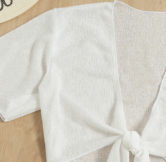 White two-piece swimwear set with a tie-front crop top and a high-waisted skirt with an asymmetrical ruffled hem. - Image 14
