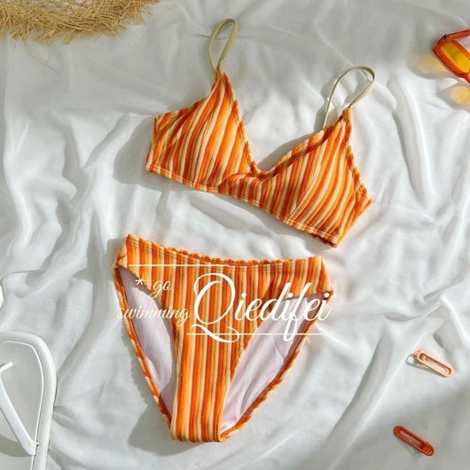 Orange and light orange striped bikini bottom with a ribbed texture and elastic waistband, ideal for beach vacations. - Image 7
