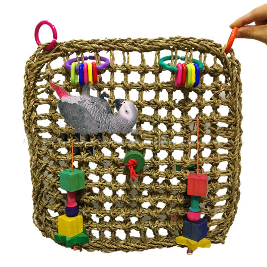 Natural straw woven parrot hammock with colorful plastic rings and wooden block toys, featuring a grey parrot. - Image 6