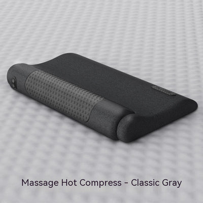 Dark gray cervical spine pillow with light gray textured massage area and power button on a light gray surface. - Image 7
