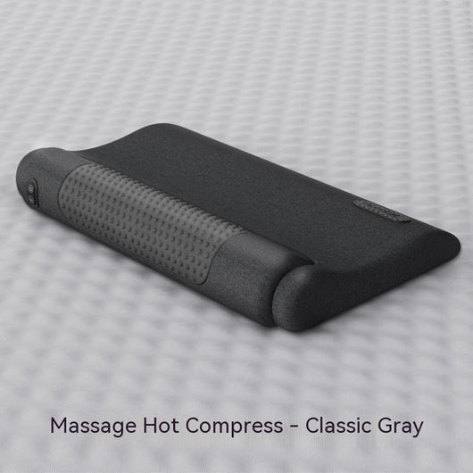 Dark gray cervical spine pillow with light gray textured massage area and power button on a light gray surface. - Image 7