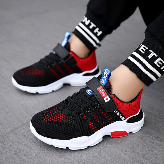 Boy's black and blue sports shoes with orange accents, mesh upper, white sole, blue laces, and a Velcro strap. - Image 23