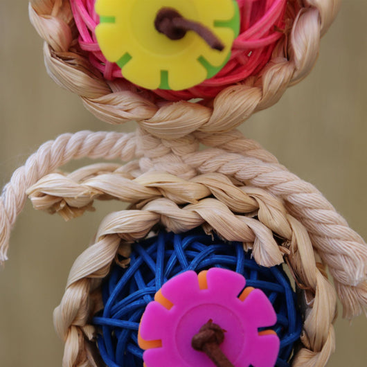 Colorful bird toy with three woven vine balls, internal pink, blue, and green string, felt flowers, and a bell. - Image 4